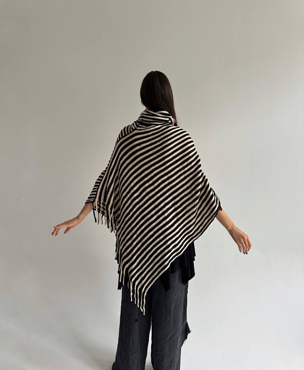 Striped poncho with tassels