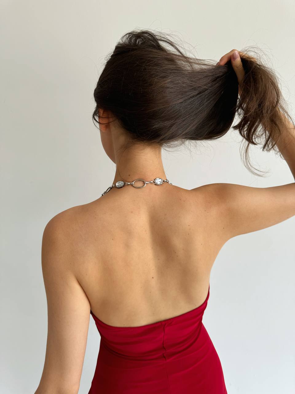 Vintage asymmetrical red dress with metallic details and crystal chain strap