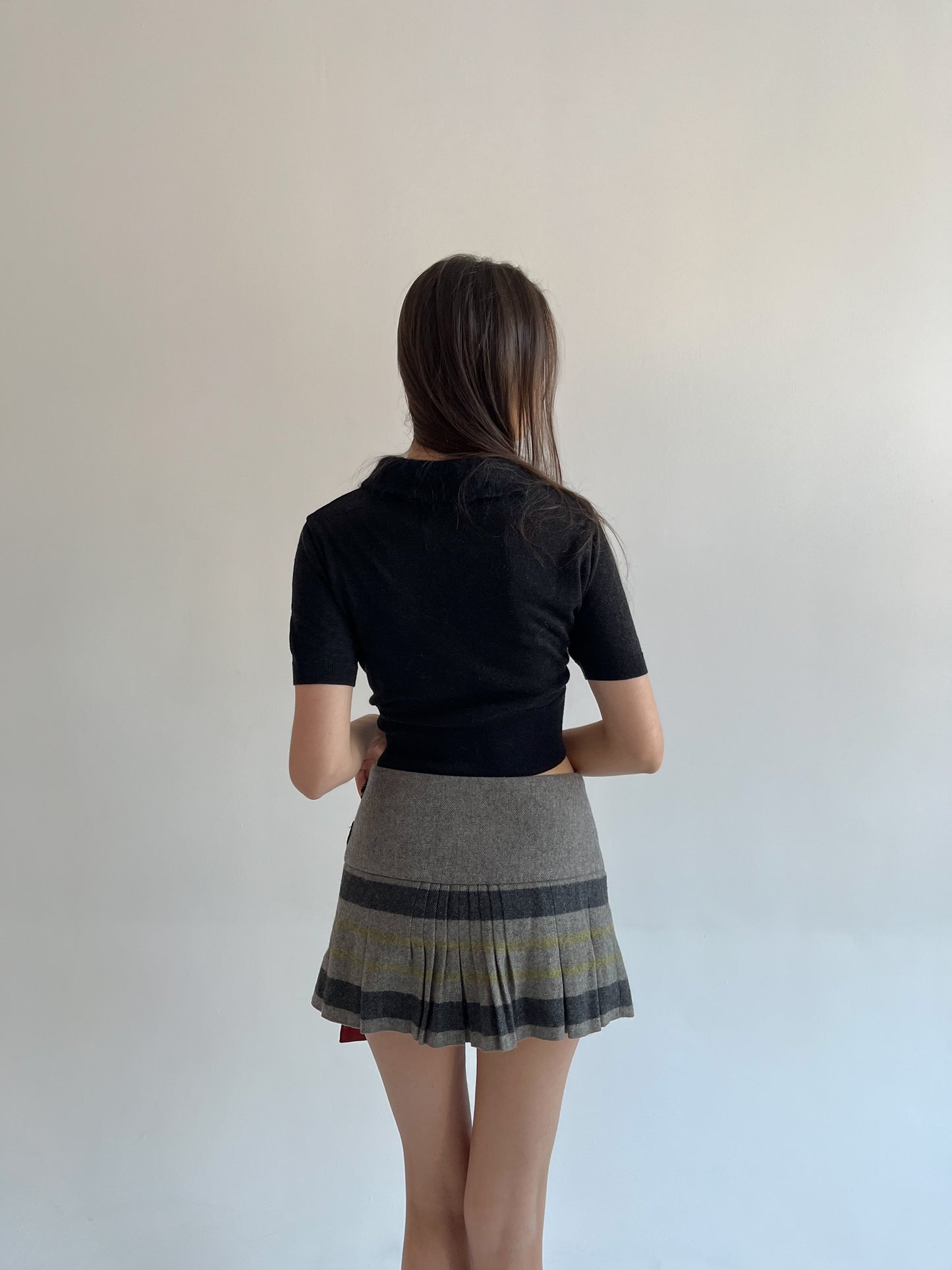 Wool blend pleated mini skirt with side belts detail